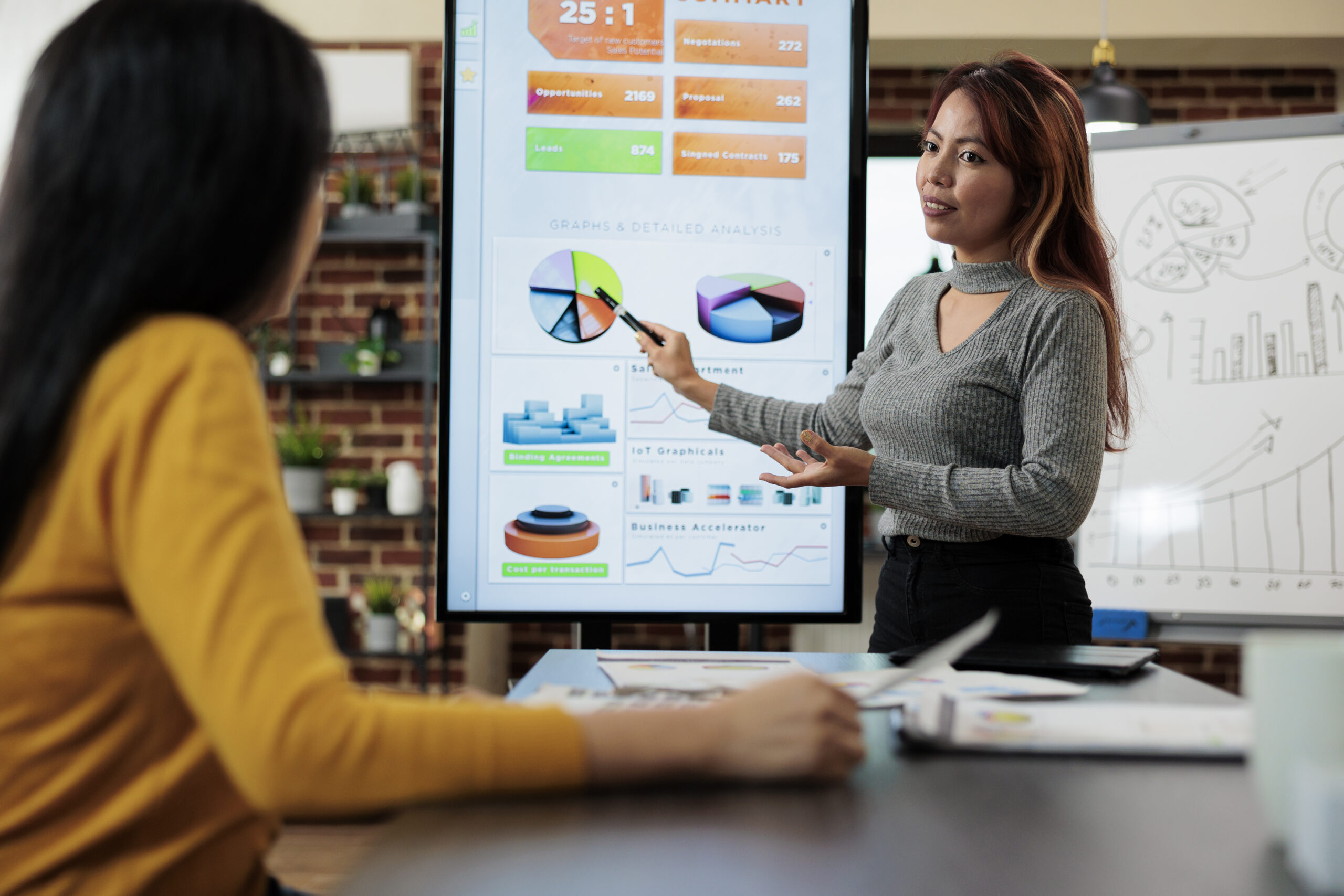 Person performing PPC A/B testing by comparing two ad versions on screen.